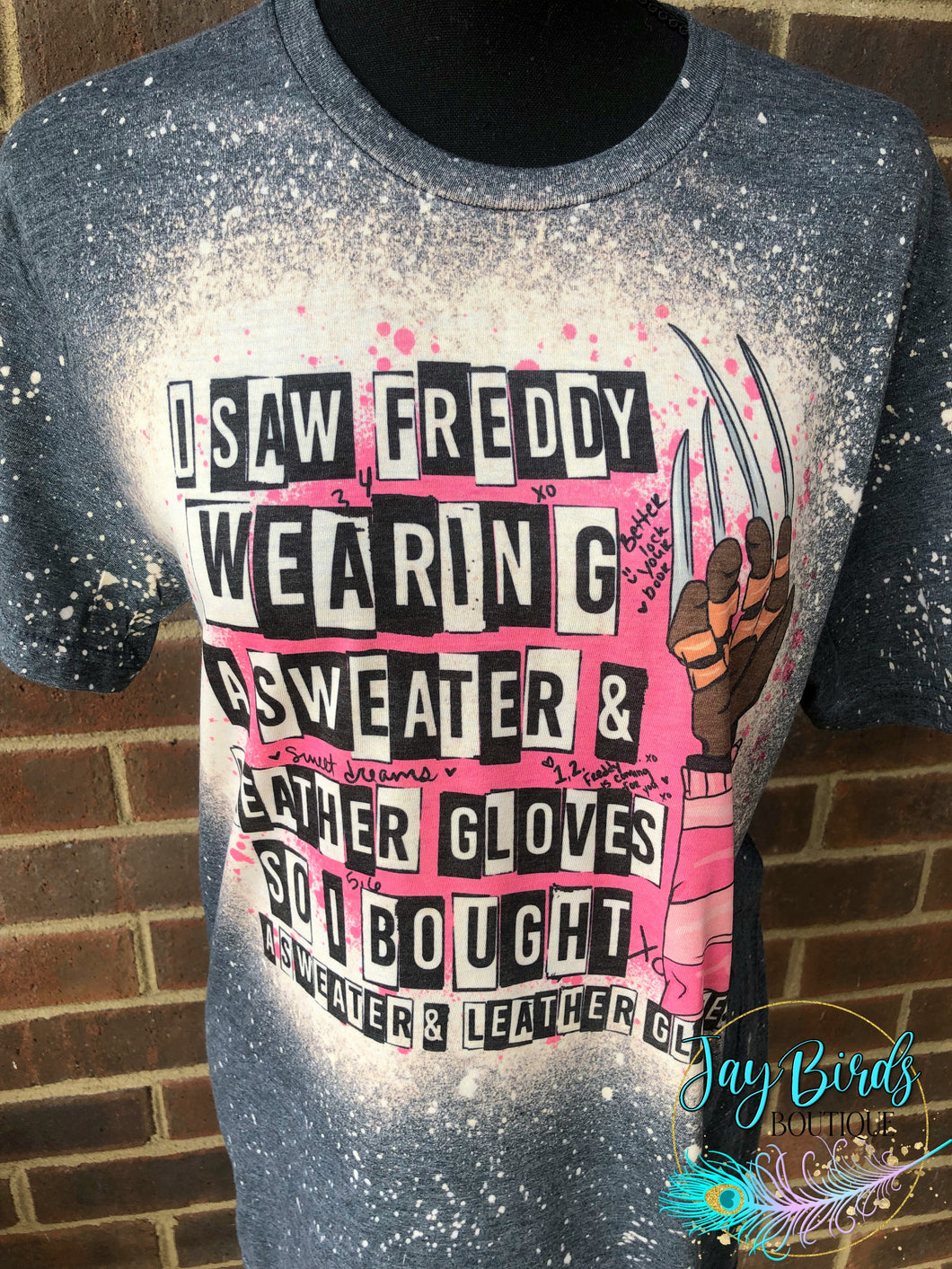 I saw freddy wearing a sweater and leather gloves..